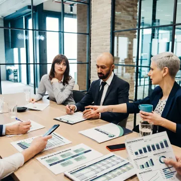 Consultants reviewing technology revenue strategy