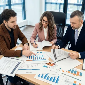 Business advisors reviewing M&A strategy documents