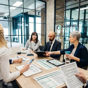 Consultants reviewing acquisition documents