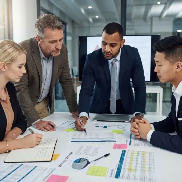 Consultants reviewing financial reports with family business owners