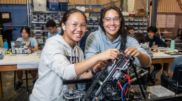 High school students building and testing robotics prototype in STEM workshop