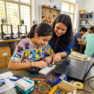Student working on a prototype with mentor guidance