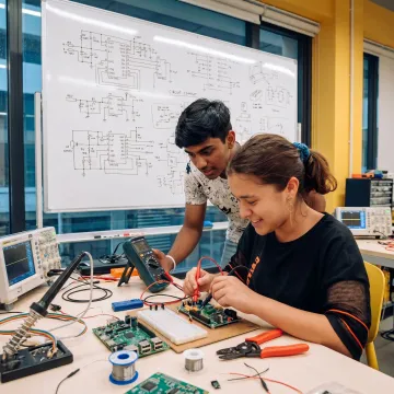 Learners prototyping electronics projects step by step