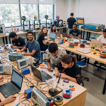 Students building hands-on projects in a makerspace