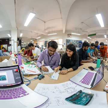 Young innovators building prototypes with mentors