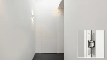 Concealed architectural door hinge installed flush inside wood door frame