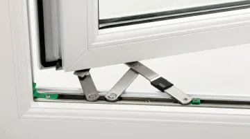 Close-up of friction hinge mechanism installed on uPVC casement window frame