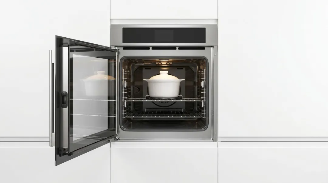 Side-swing oven door open more than 100 degrees showing ergonomic front access design