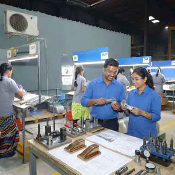 Engineers reviewing custom bracket components and production drawings