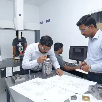 Engineers reviewing tool and die production process