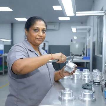Technician inspecting assembled metal components