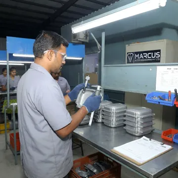 Technician inspecting coated assembled components