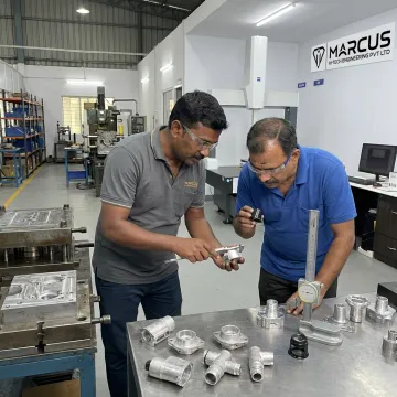 Engineers inspecting aluminum die-cast connector components