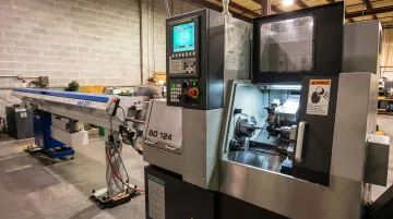 Modern Swiss CNC screw machine in production shop floor manufacturing environment