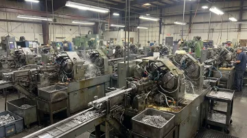 Multi-spindle screw machine performing simultaneous operations on high-volume production run