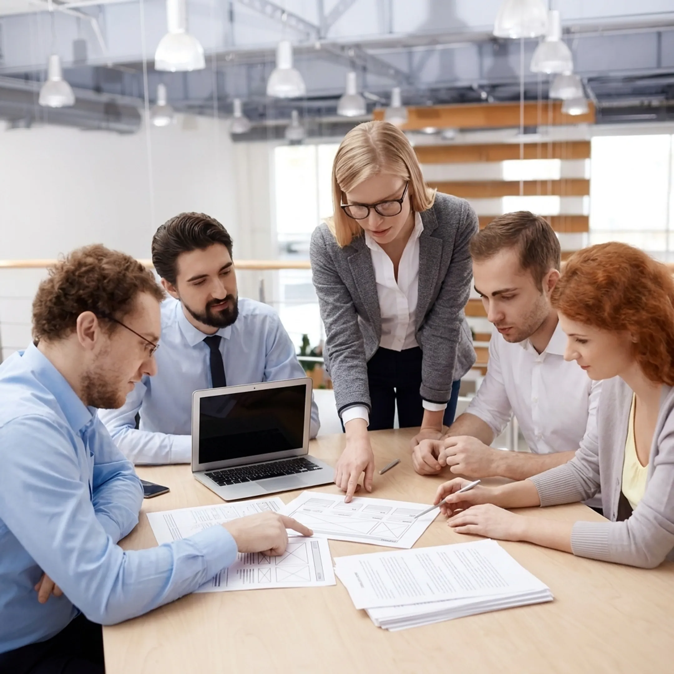 Team planning a business website on a laptop