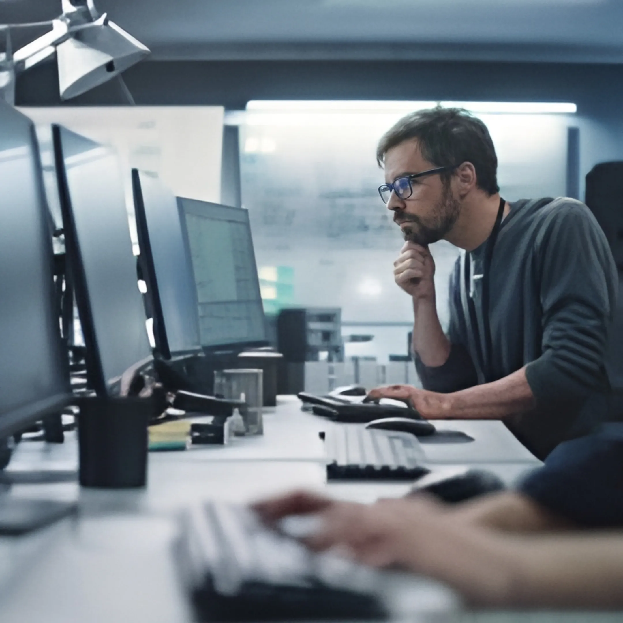 Network operations specialist reviewing system alerts