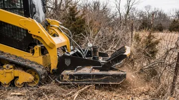 Maxx Attachments Vortex Brushcutter mounted on skid steer in field
