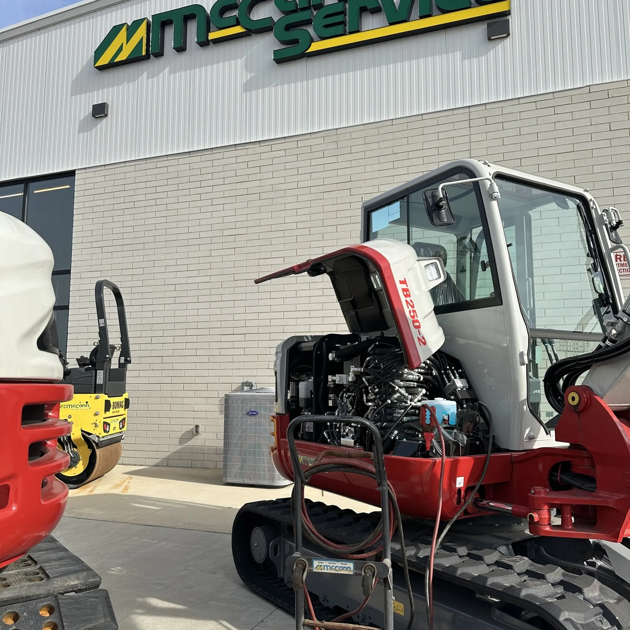 Mobile technician diagnosing construction equipment