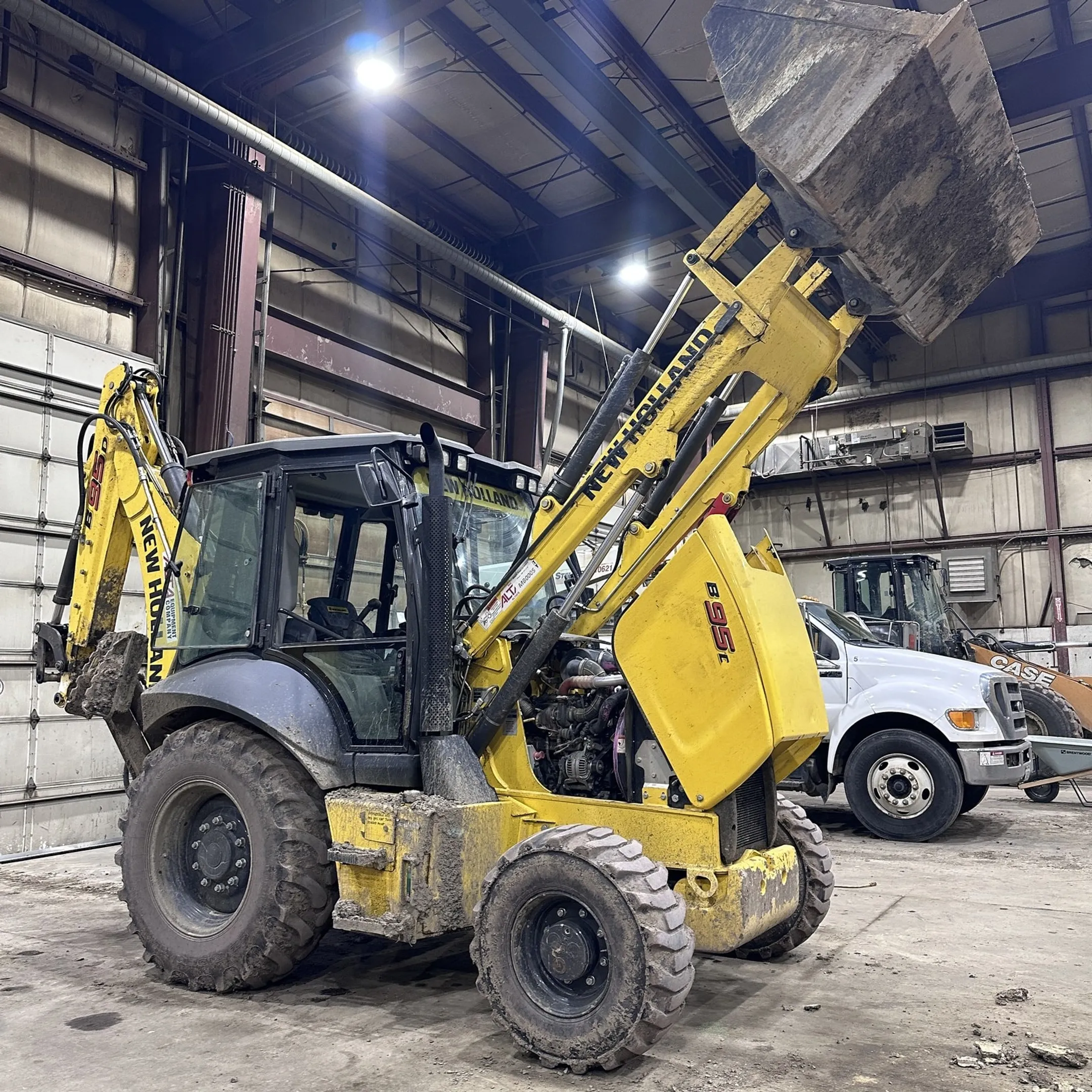 Technician repairing a hydraulic cylinder in a service facility