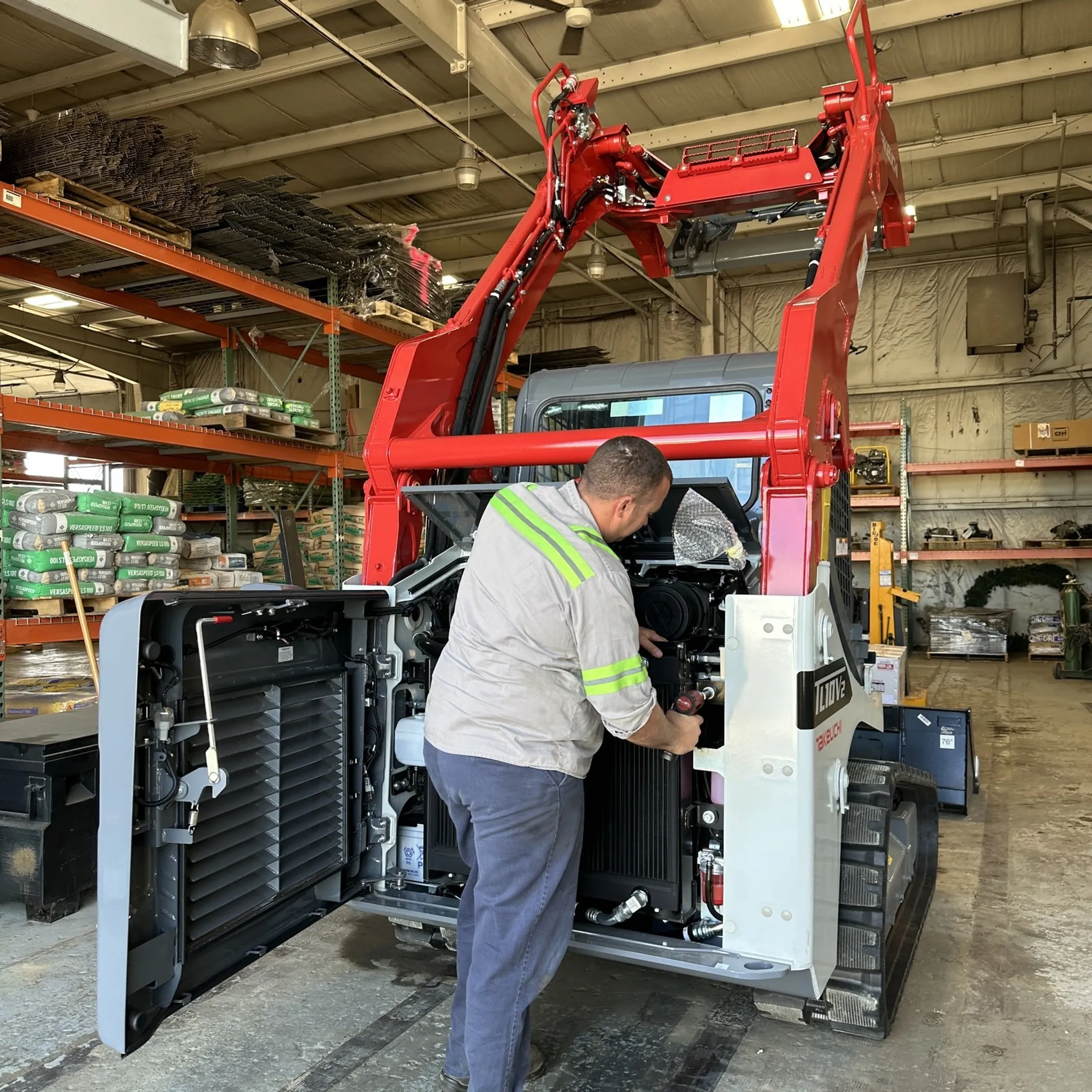 Technician diagnosing a heavy equipment diesel engine