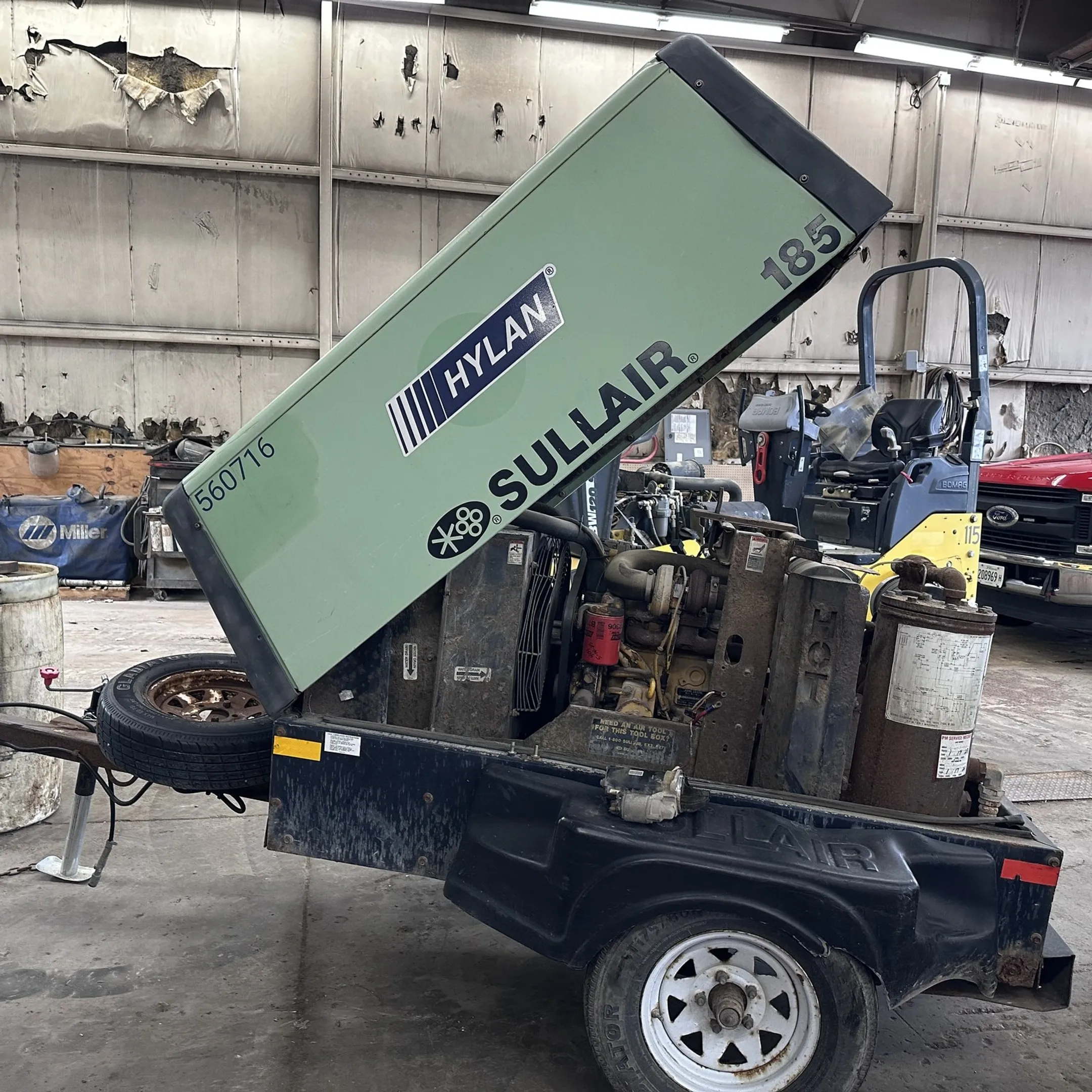 Technician diagnosing construction equipment at a jobsite
