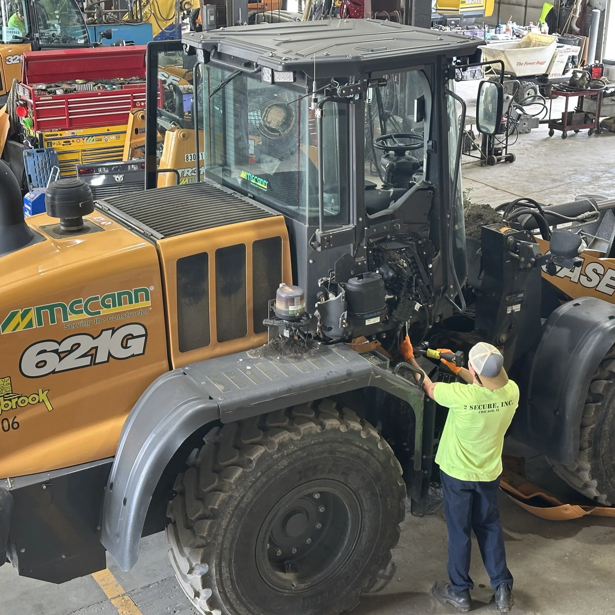 Technician diagnosing a hydraulic cylinder on construction equipment
