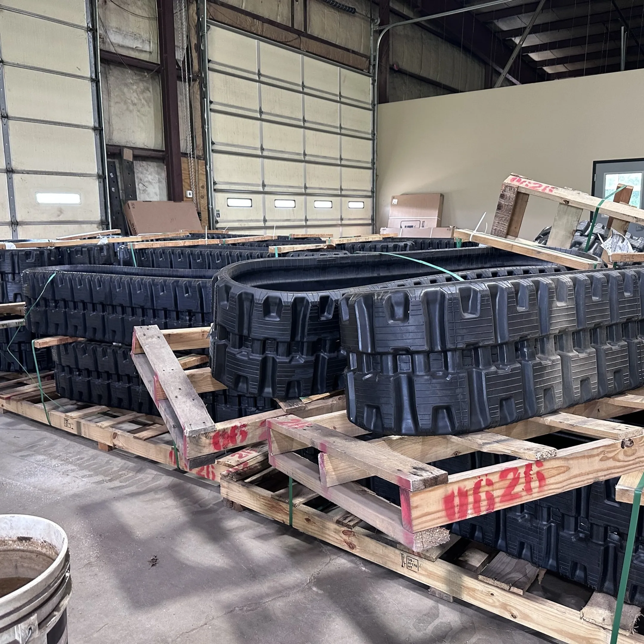 Technician repairing excavator undercarriage components