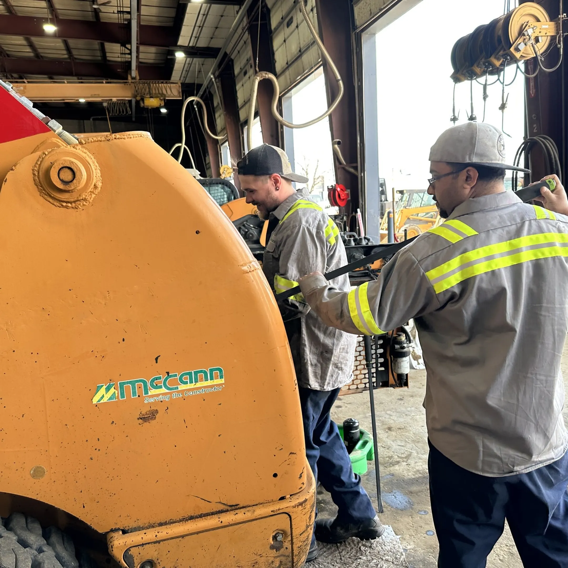 Factory-trained technician inspecting a heavy equipment hydraulic system
