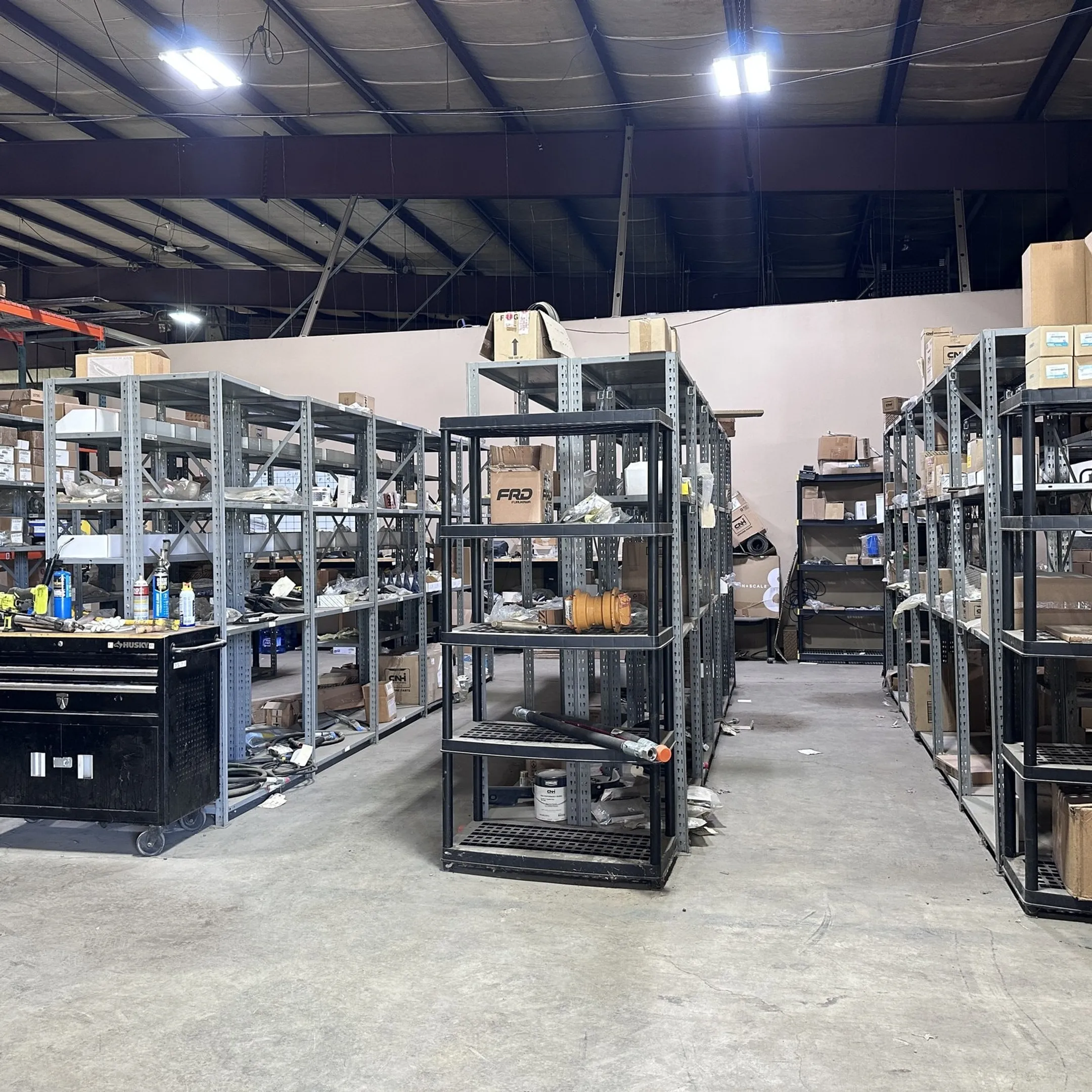 Technician reviewing construction equipment components for repair and maintenance