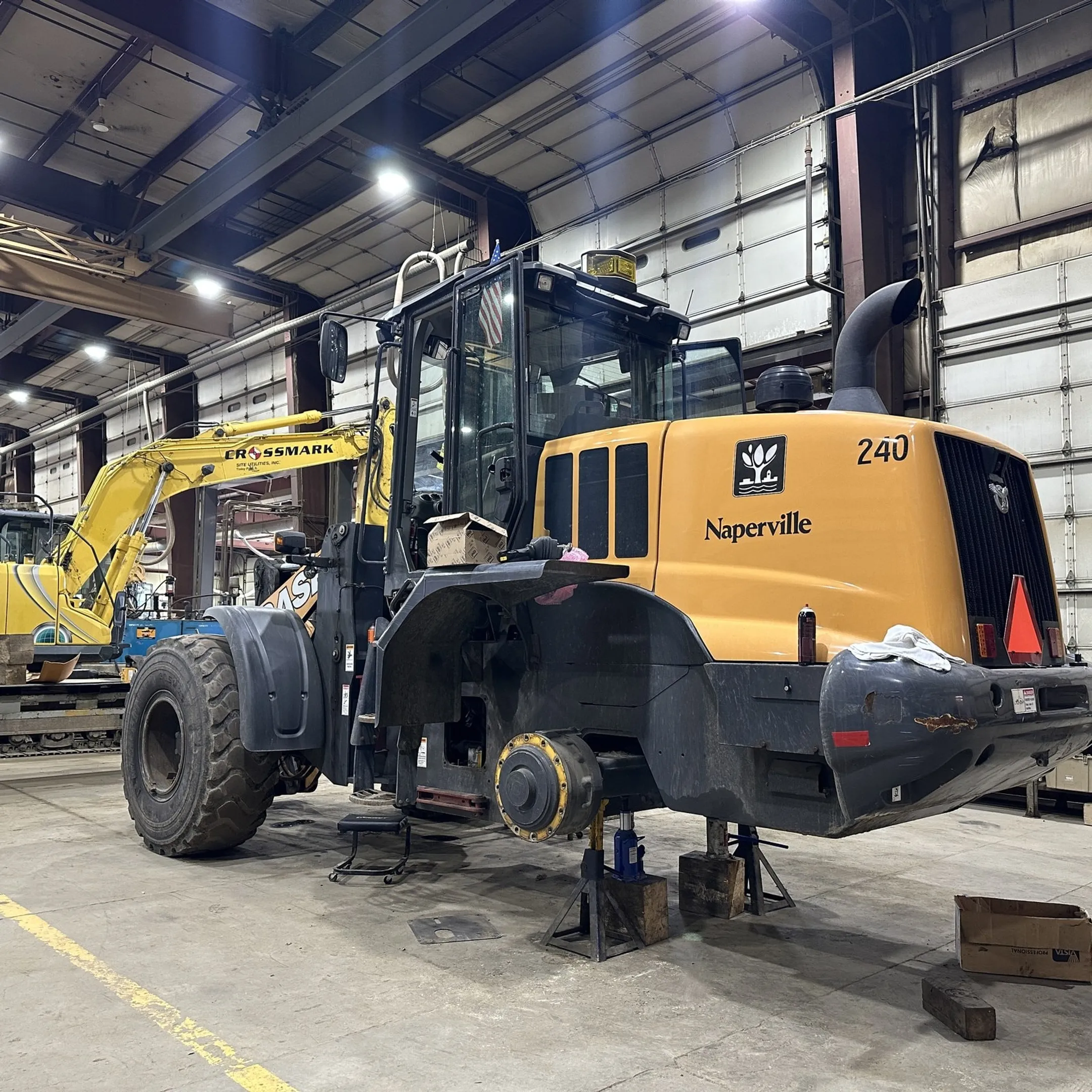 Mobile technician diagnosing heavy equipment hydraulics