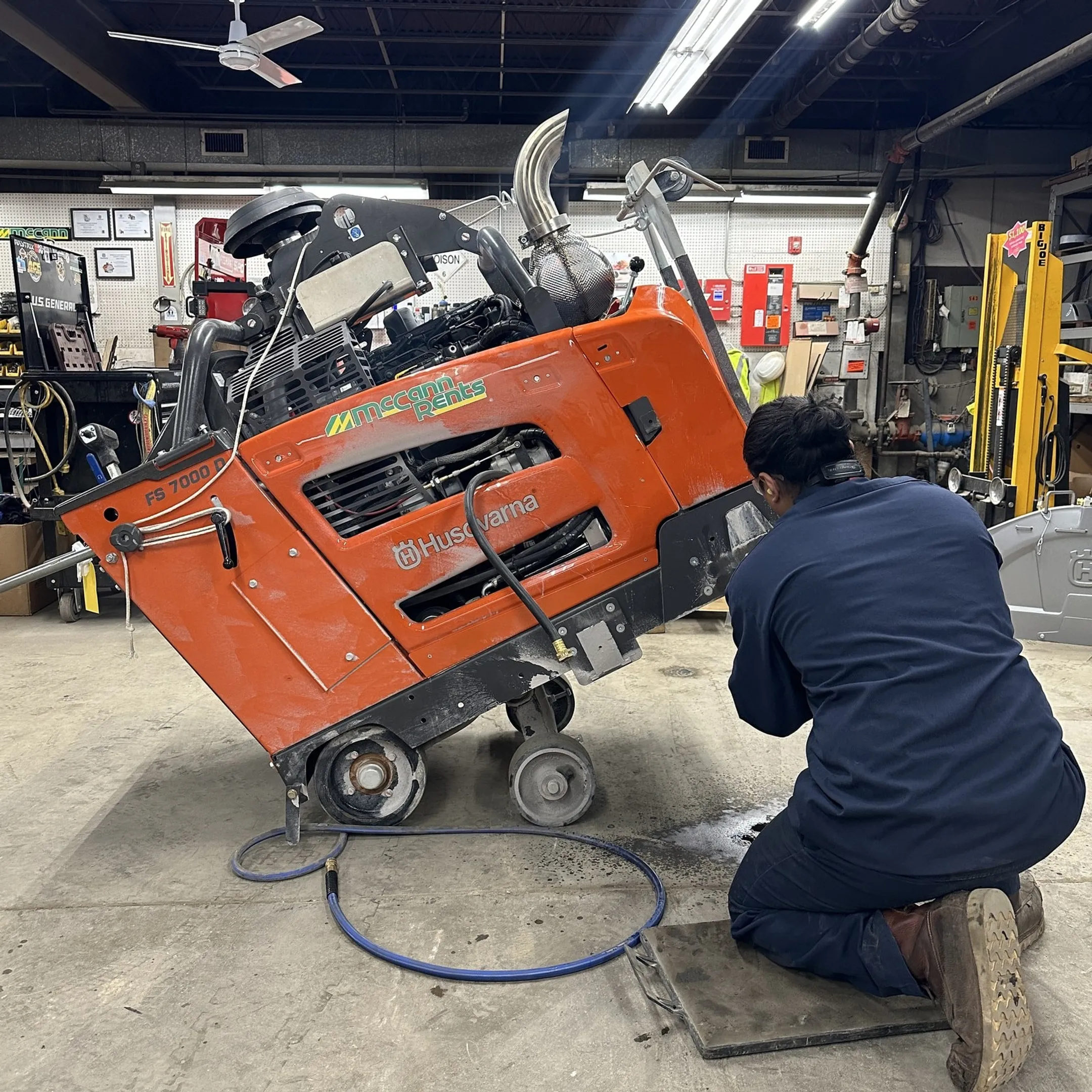 Technician testing a repaired construction tool