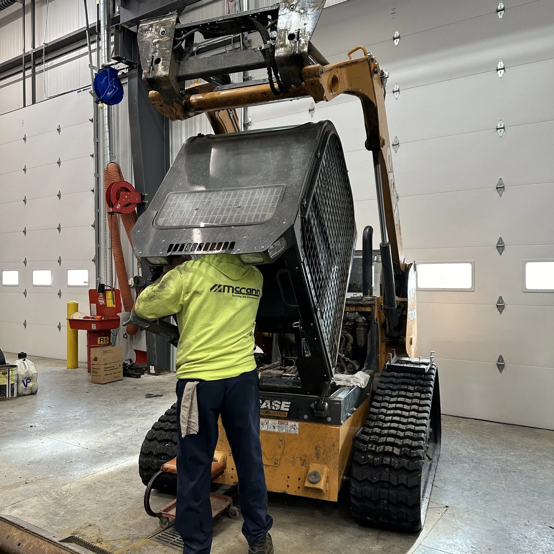 Technician diagnosing a heavy equipment hydraulic system