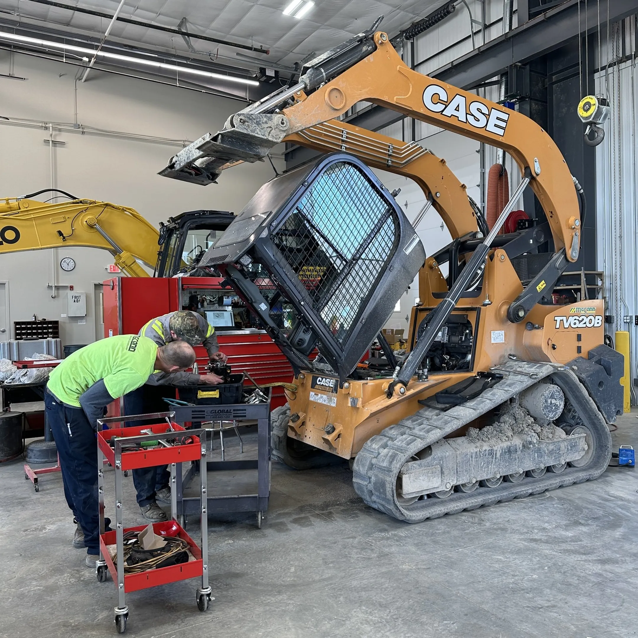 Mobile technician diagnosing a construction machine on site
