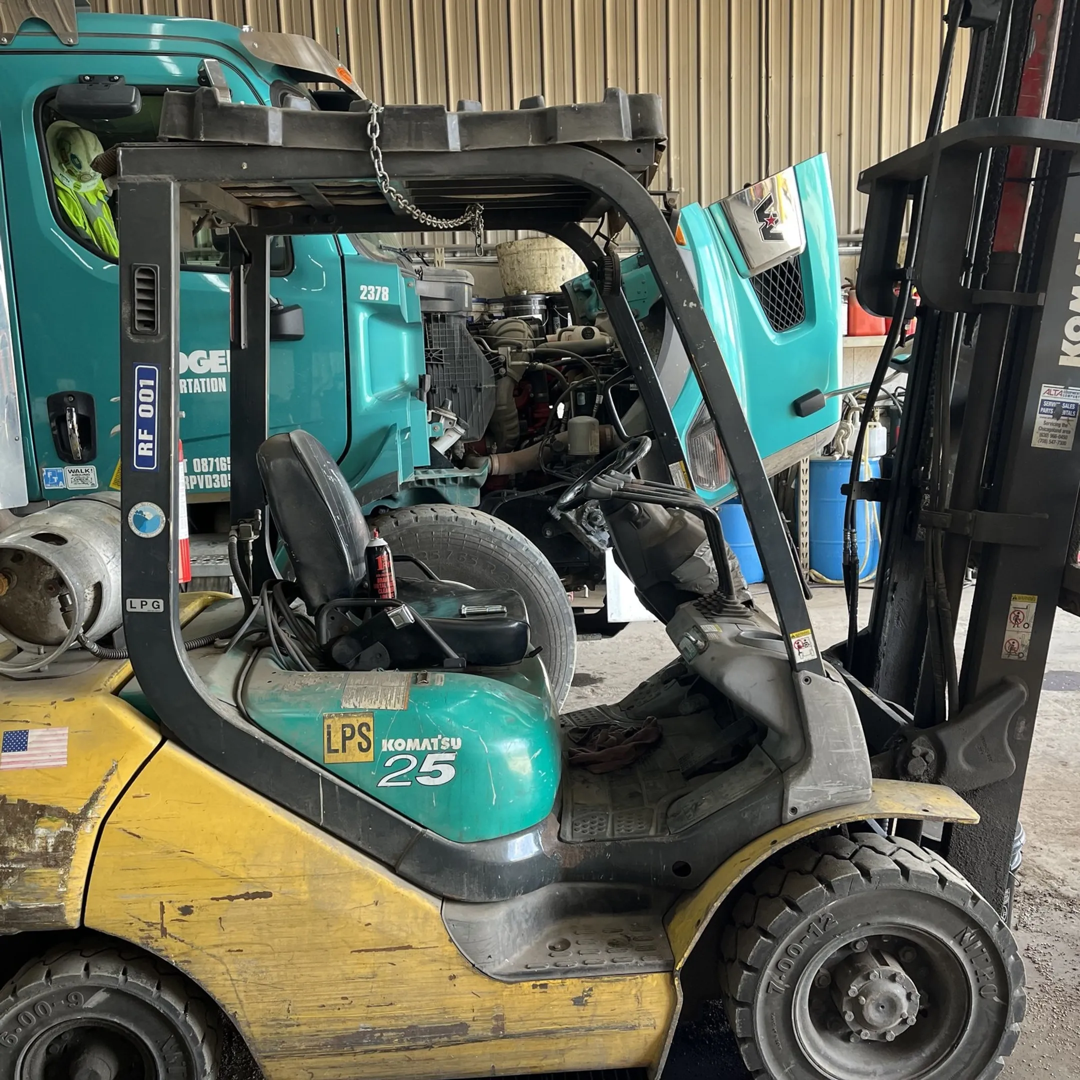 Mobile technician diagnosing forklift equipment
