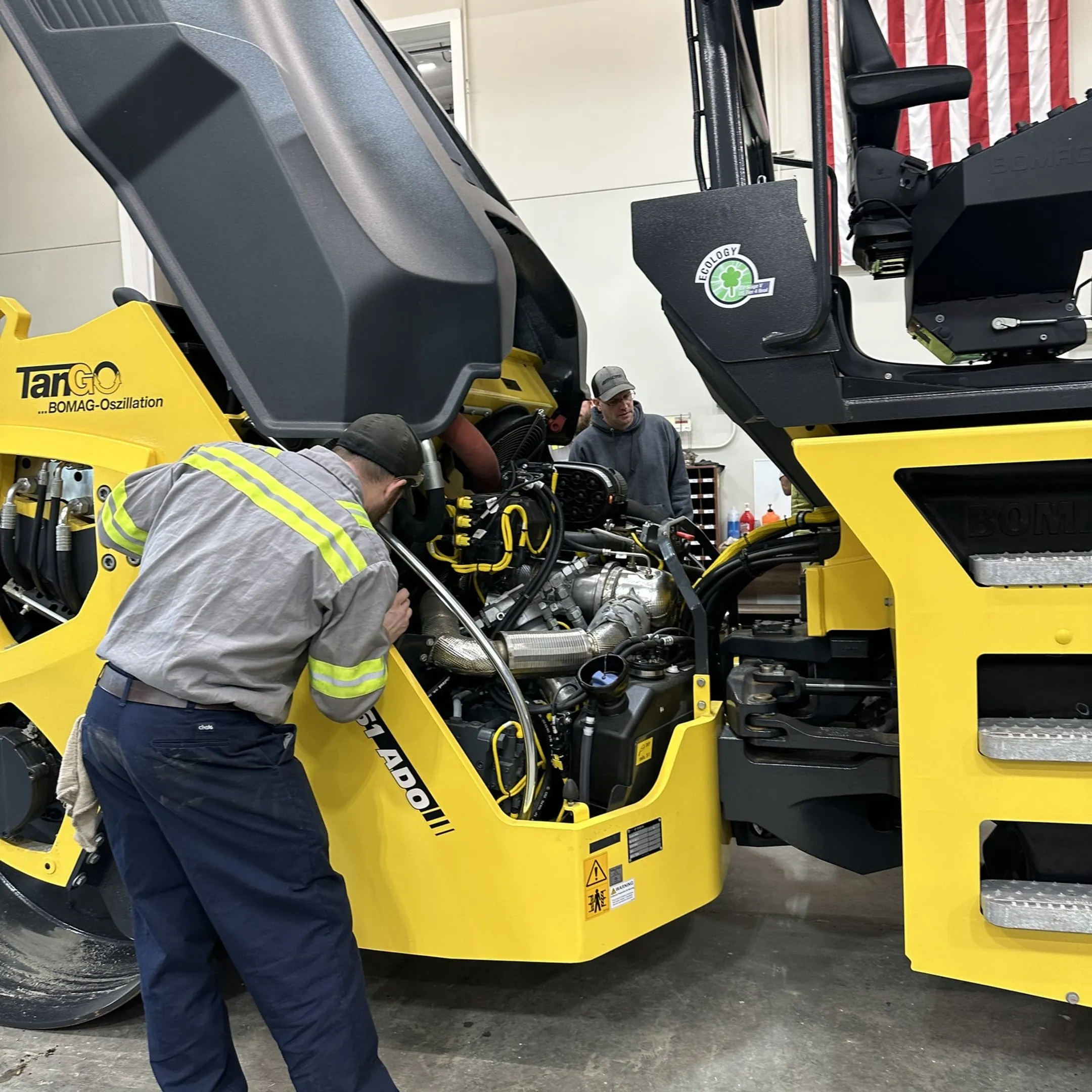 Mobile technician diagnosing a diesel engine on construction equipment