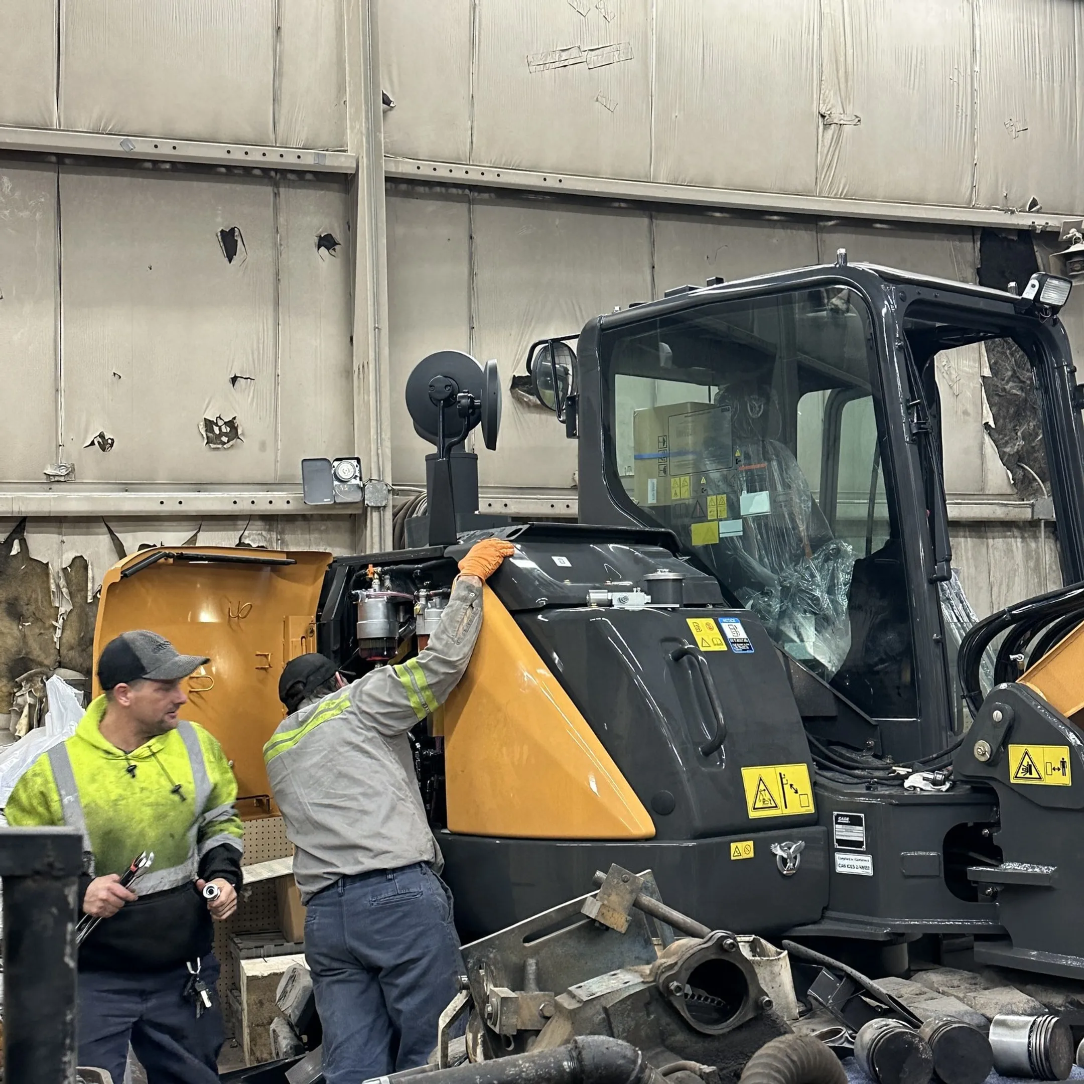 Technician diagnosing a construction equipment hydraulic system