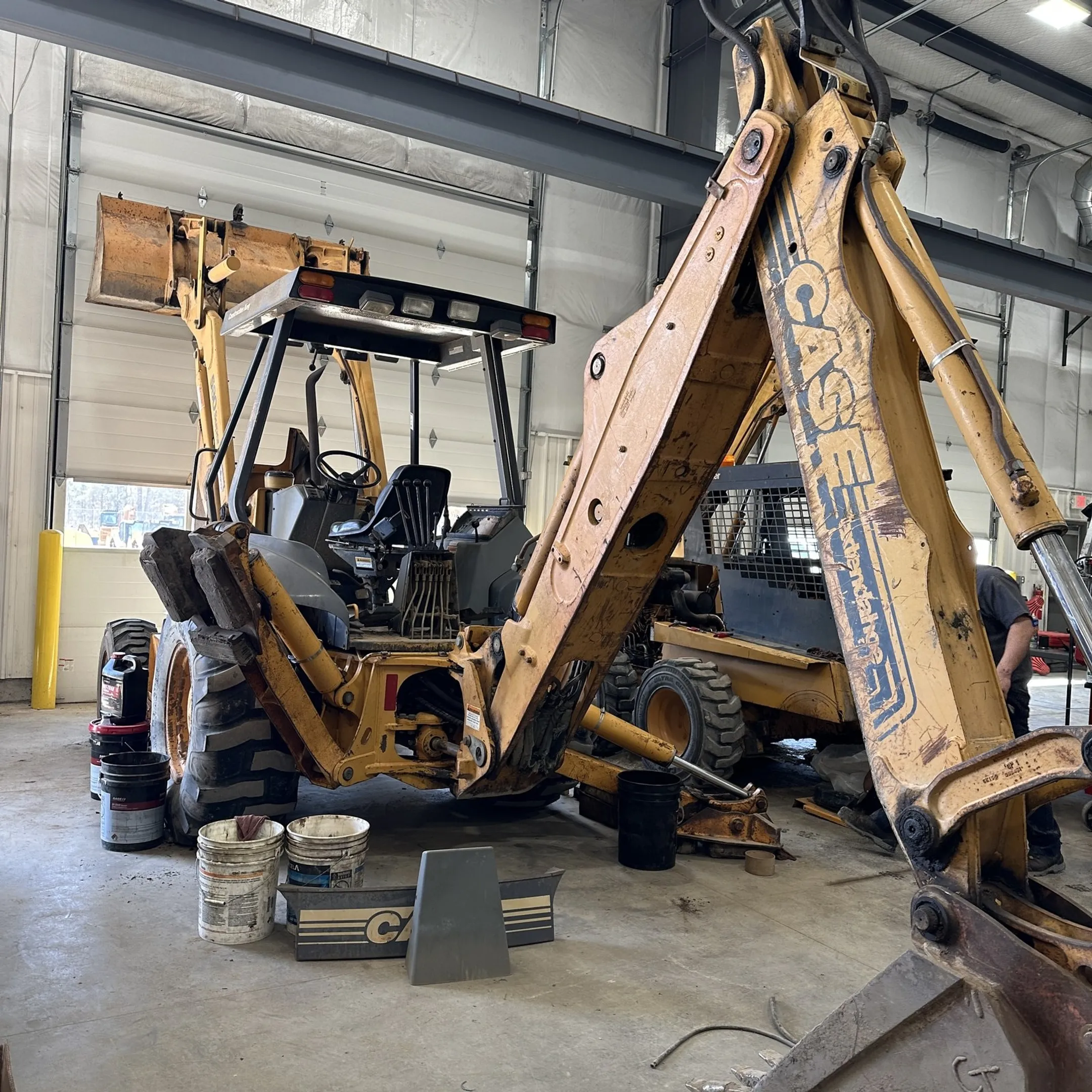 Technician repairing a hydraulic cylinder and hose assembly
