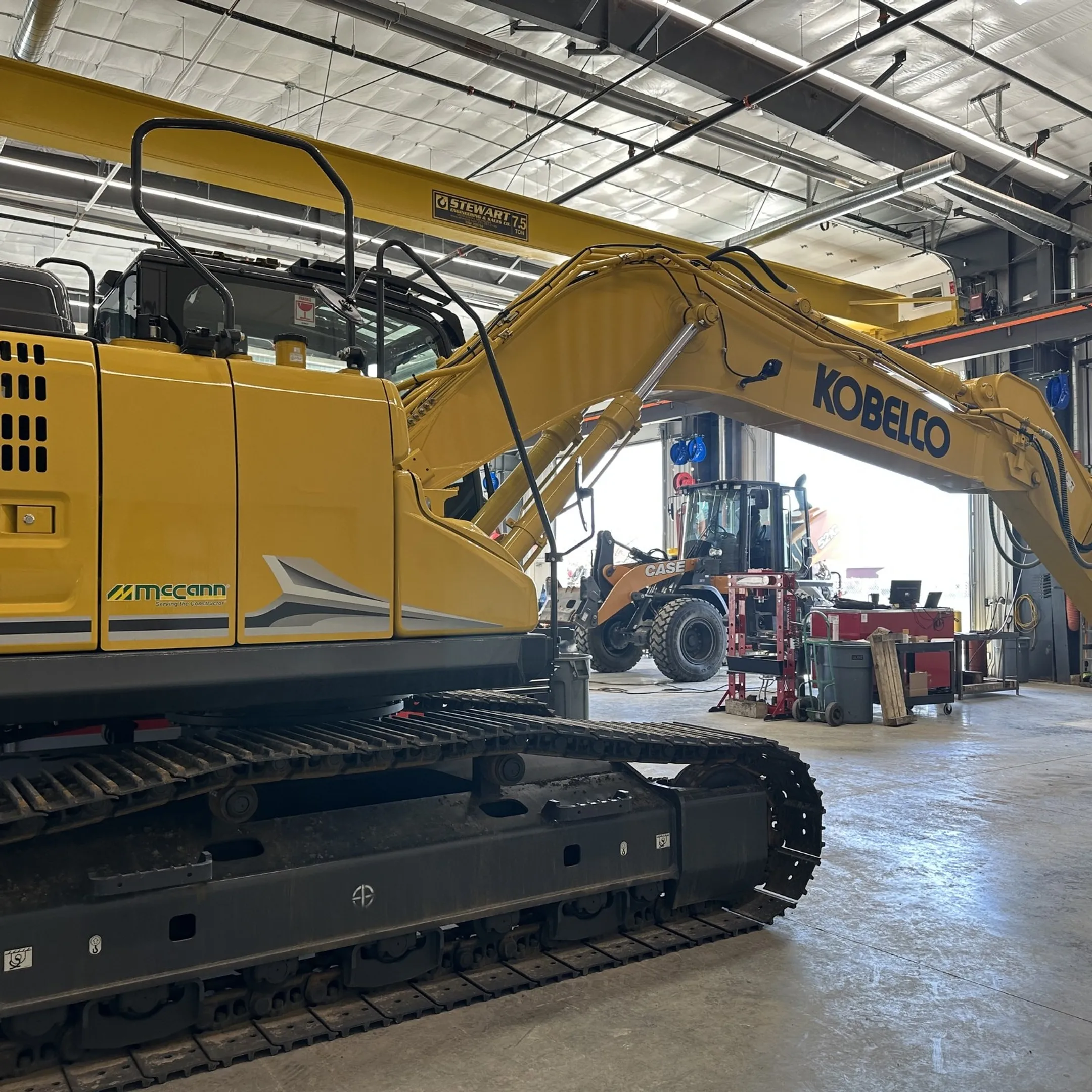 Technician rebuilding a hydraulic cylinder in an equipment repair shop