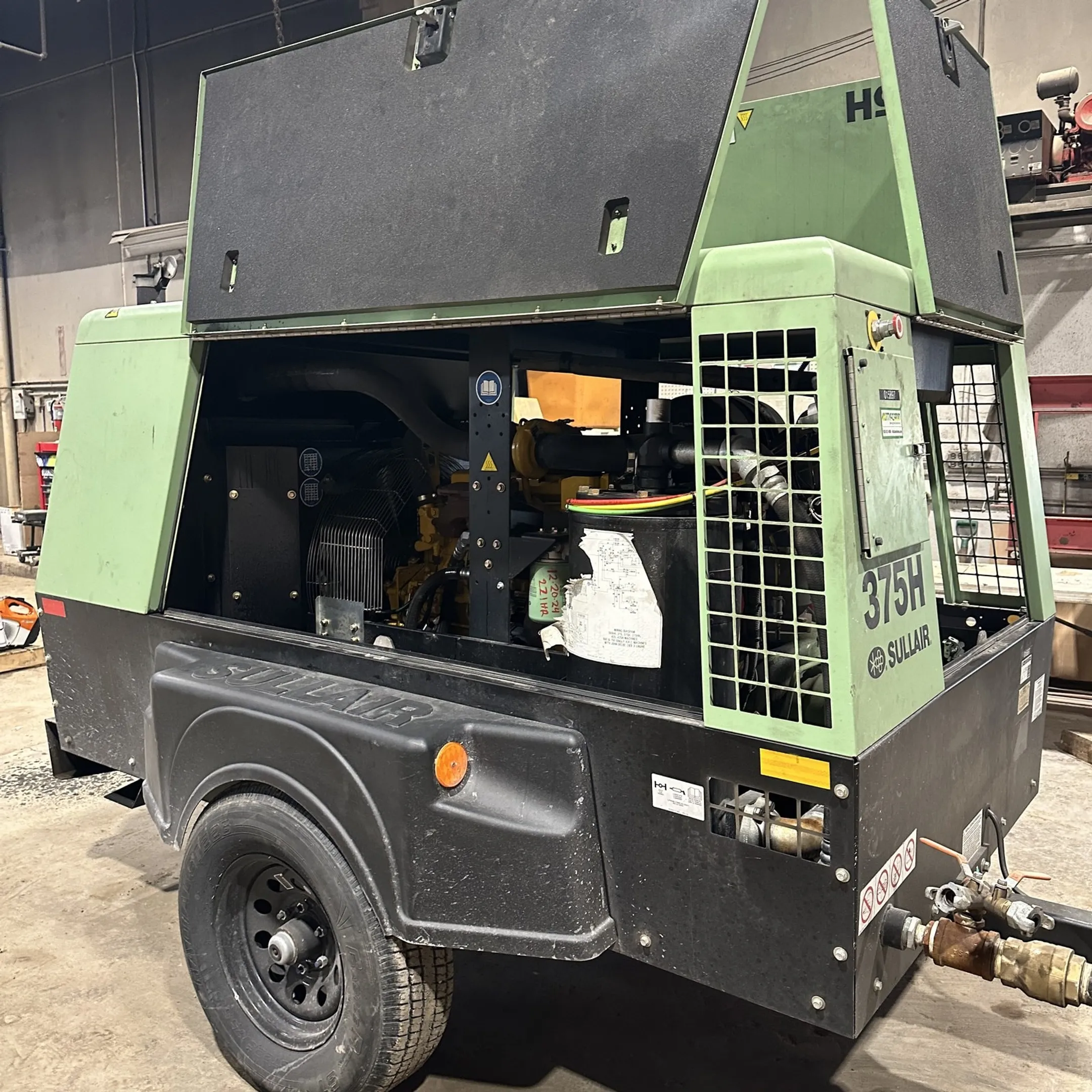McCann technician diagnosing diesel equipment with a mobile service truck nearby