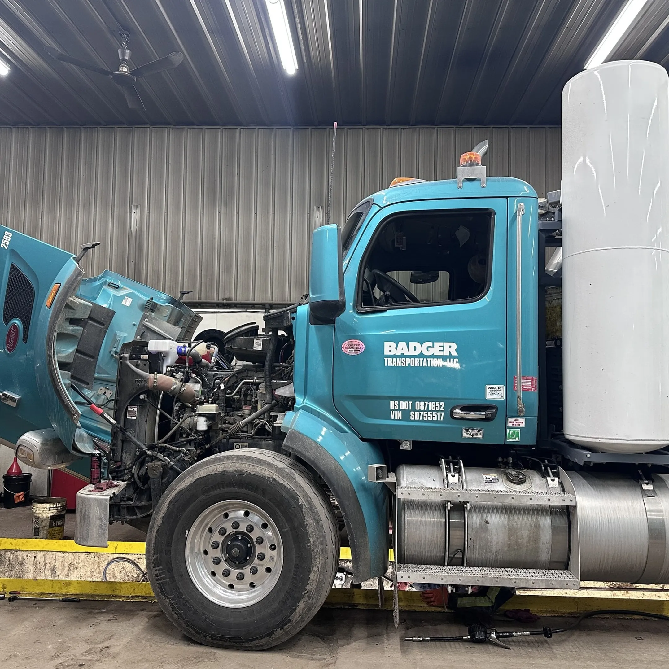 Construction fleet receiving scheduled maintenance from a service technician