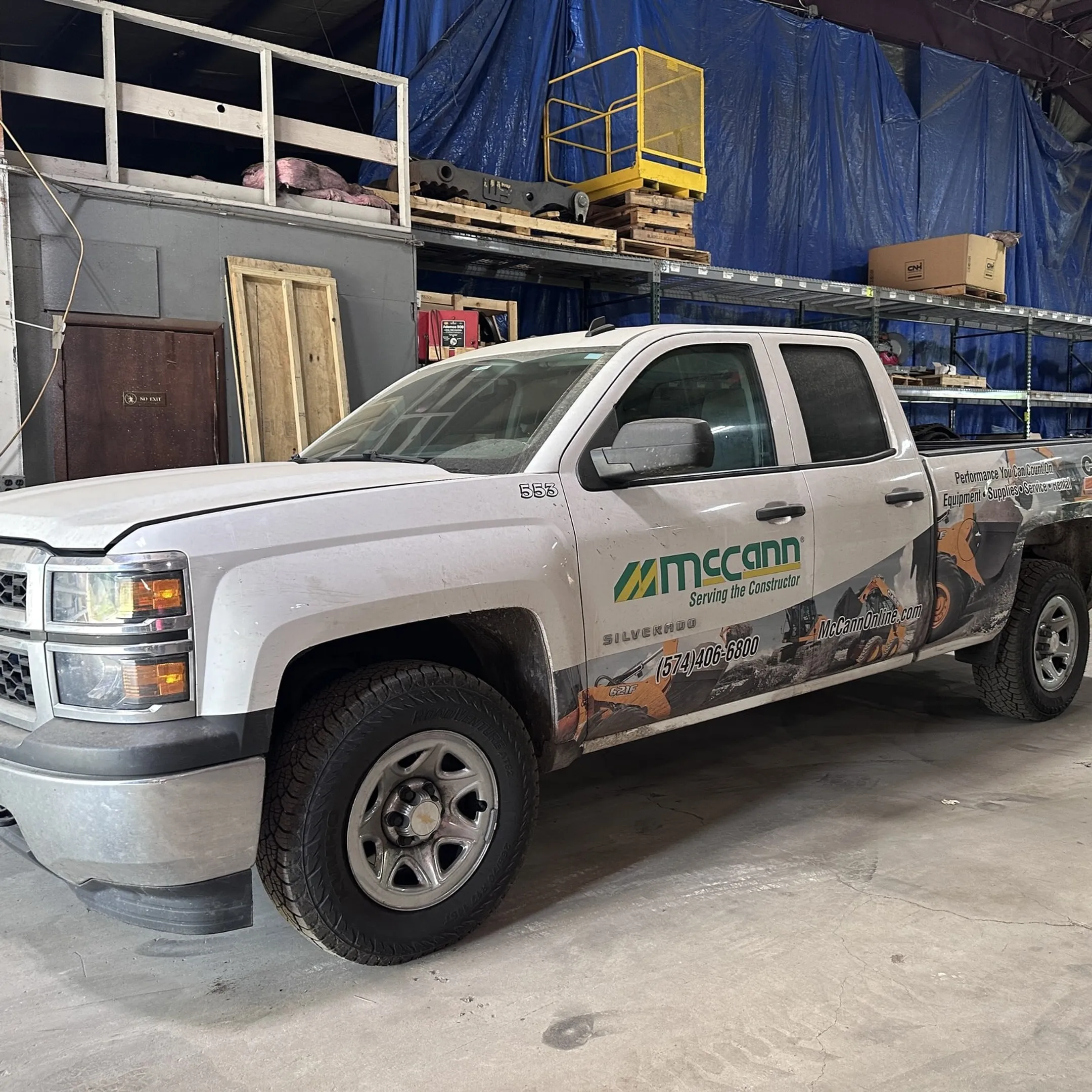 McCann technician servicing a construction machine at a jobsite