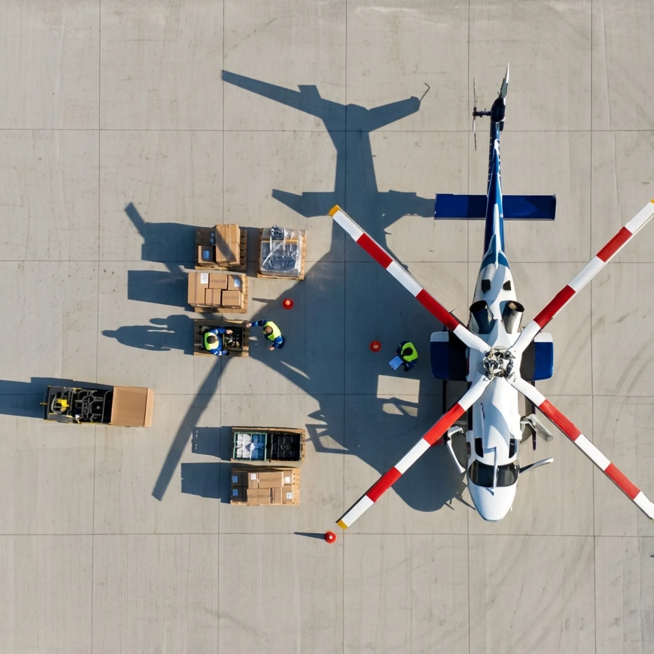 Operations team coordinating helicopter cargo shipment