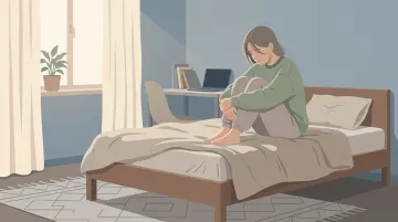 Teenager sitting alone withdrawn in bedroom showing signs of emotional distress