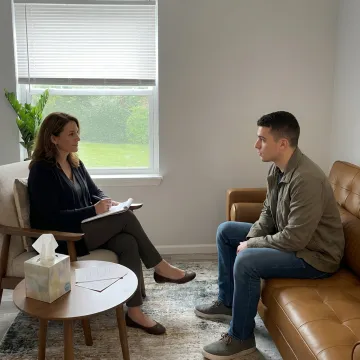 Therapist supporting a young adult in session