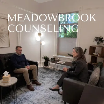 Counselor speaking with grieving adult client in a calm therapy office