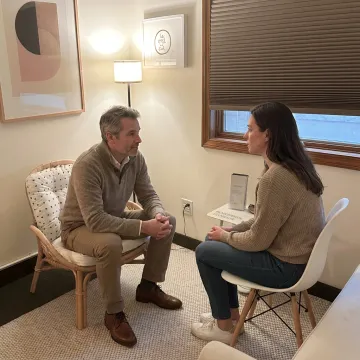 Therapist speaking with client in counseling office