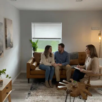 Couple speaking with a therapist in a calm counseling office