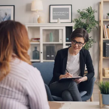 Therapist listening to a young client