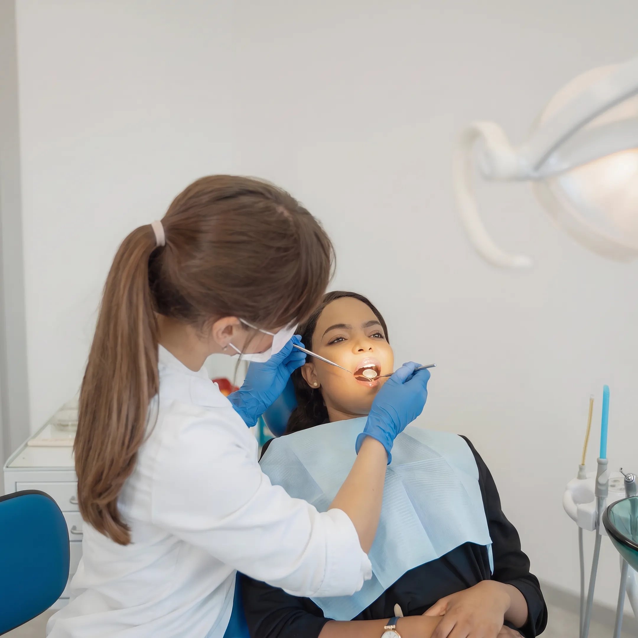 Patient receiving a dental cleaning from a dentist in a Florida clinic